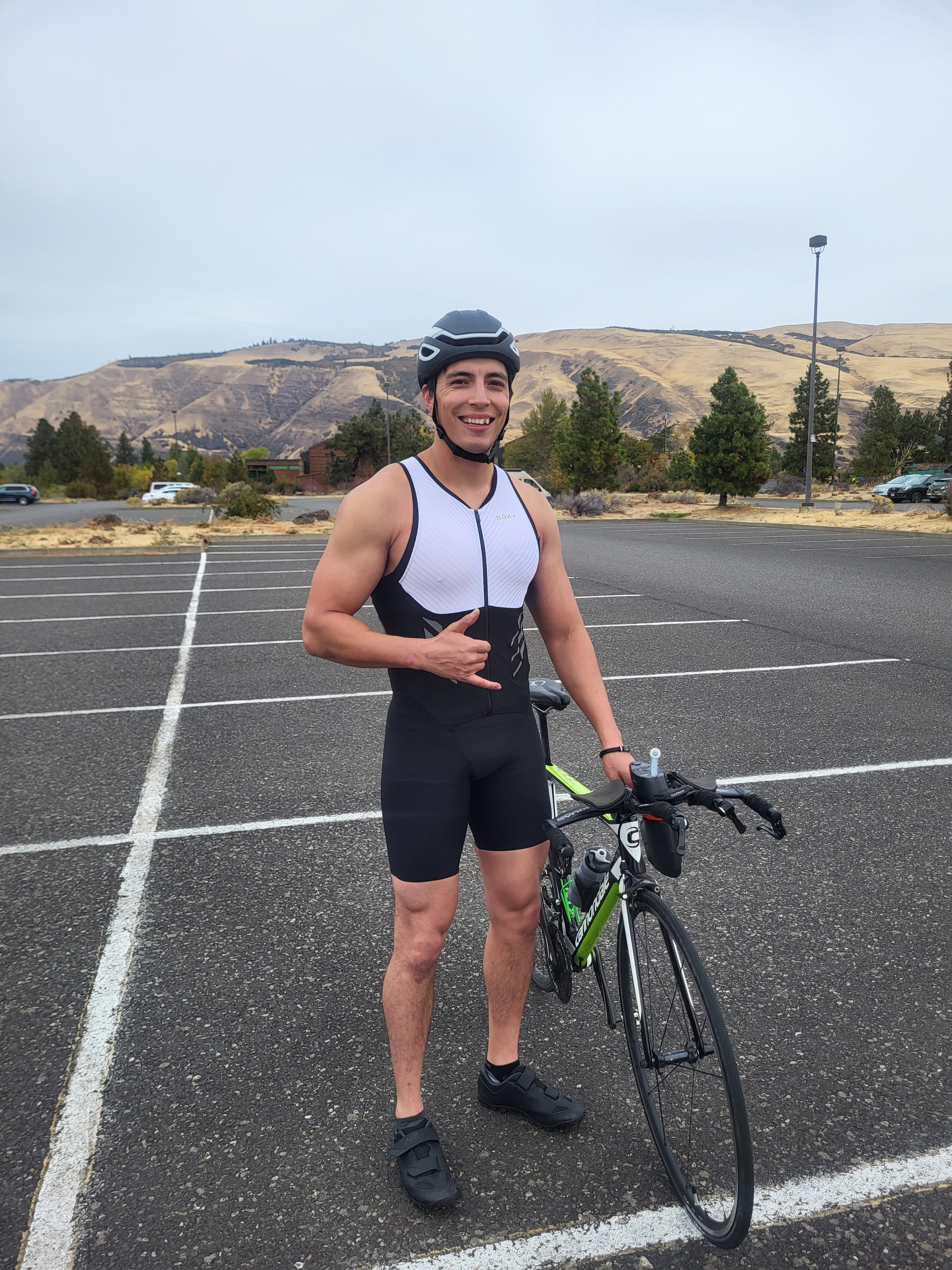Eddie cycling on an open road during triathlon training